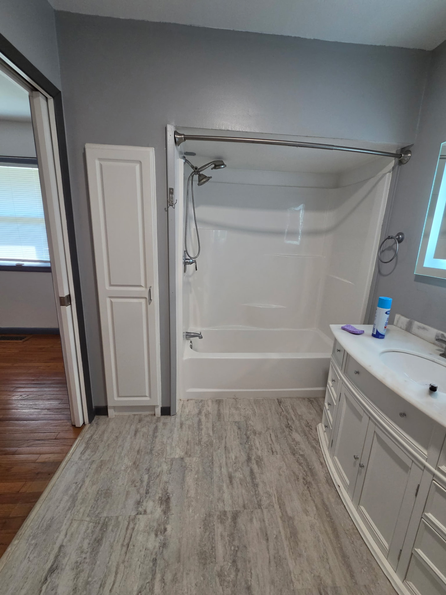 Bathroom with newly painted gray walls and white trim