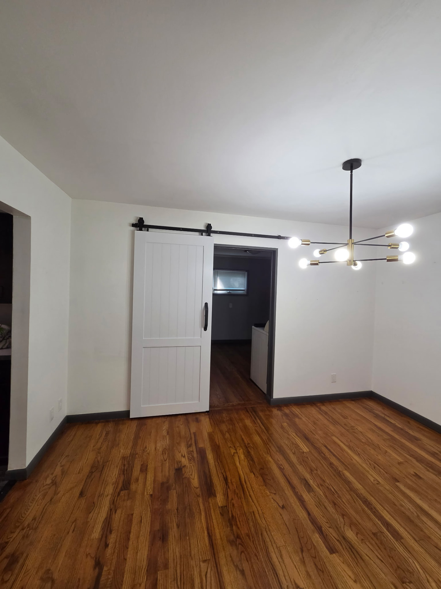 Before painting: dining room with older white walls and gray trim
