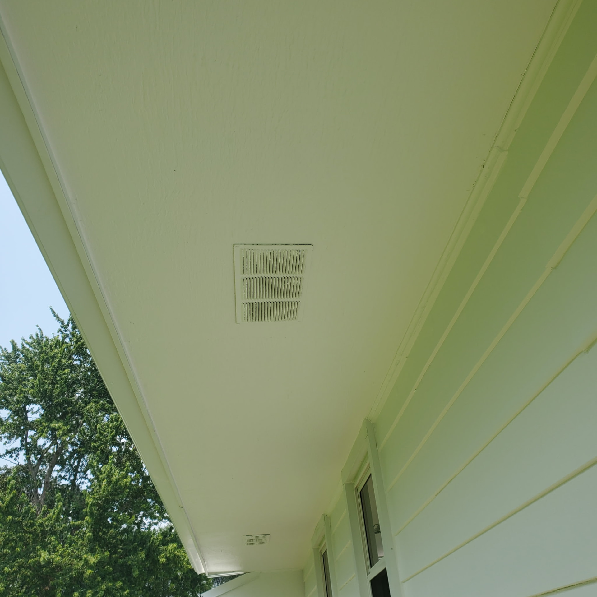 Exterior soffit and siding freshly painted by Patriot Painting